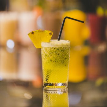 A vertical closeup shot of a non-alcoholic drink on blurred background